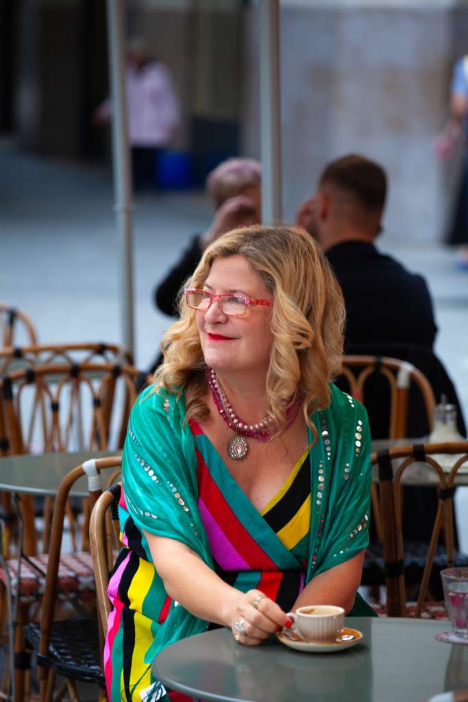 Sarah at a Paris cafe table with a coffee