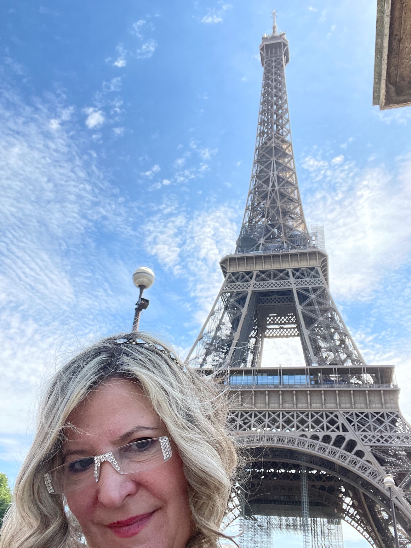 Sarah with a crystal tiara in front of the Eiffel Tower